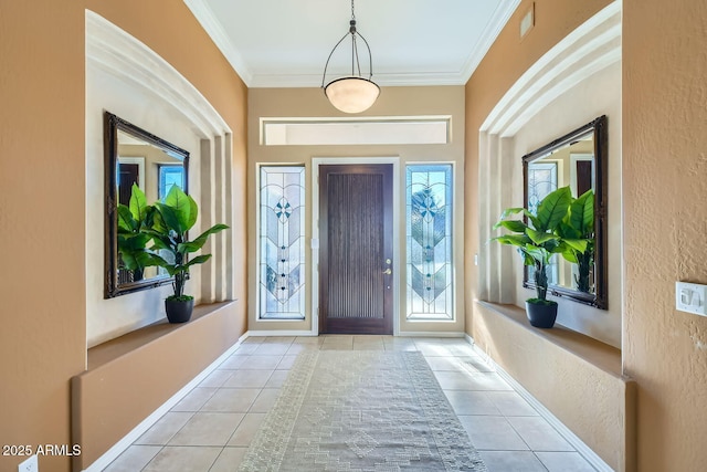 entrance foyer with ornamental molding and light tile patterned floors