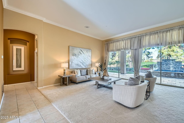 living room with ornamental molding and light tile patterned floors