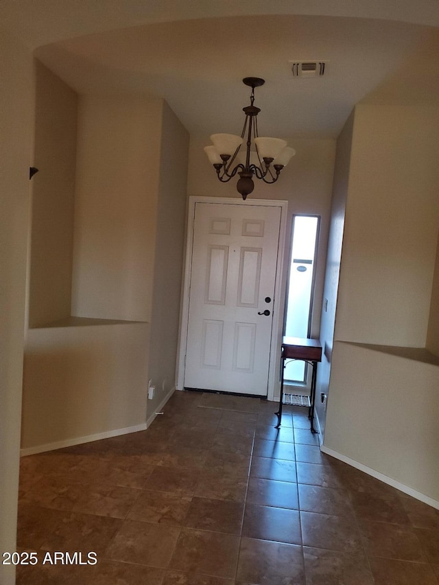 entryway with a notable chandelier