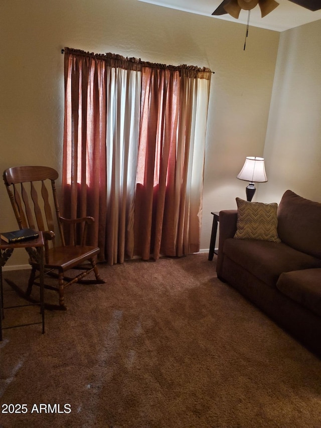 carpeted living room with ceiling fan