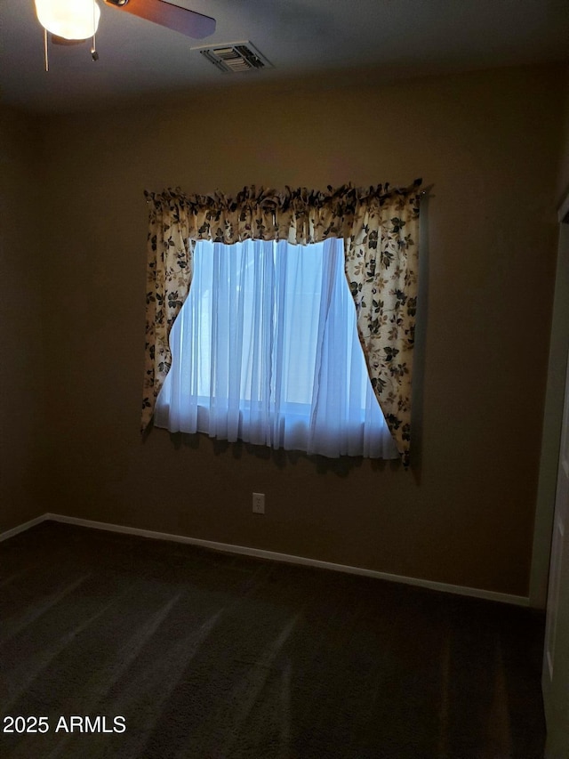 carpeted spare room with ceiling fan