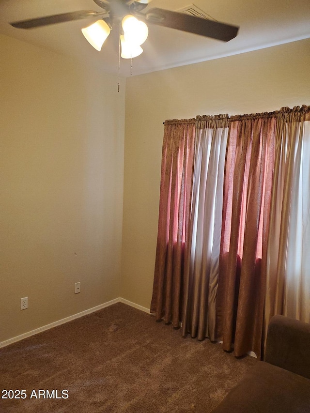 empty room featuring ceiling fan and carpet flooring