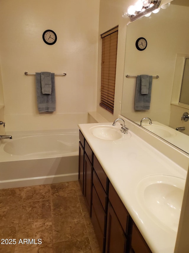 bathroom with vanity and a washtub