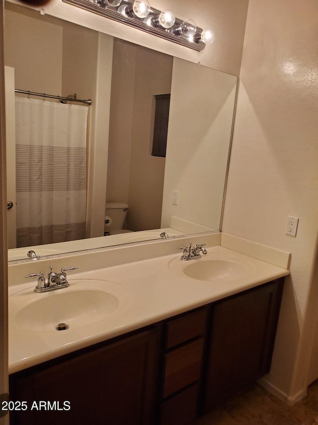 bathroom with vanity and toilet