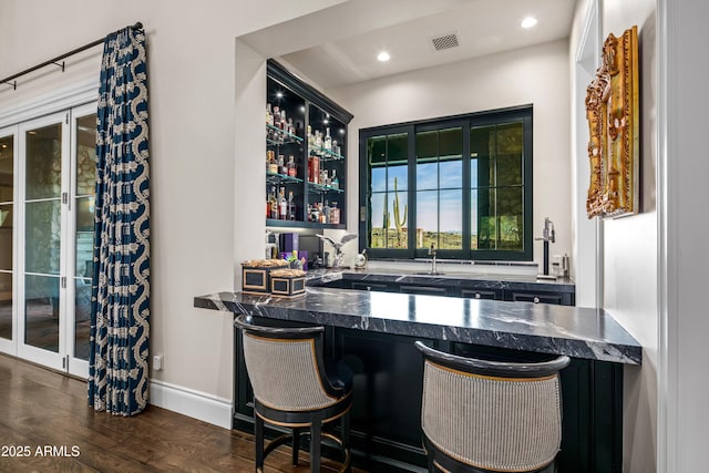 bar with dark wood-type flooring