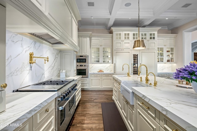 kitchen featuring beam ceiling, double oven range, coffered ceiling, and tasteful backsplash