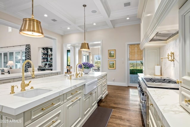 kitchen featuring coffered ceiling, hanging light fixtures, double oven range, beam ceiling, and sink