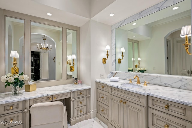 bathroom featuring a notable chandelier and vanity