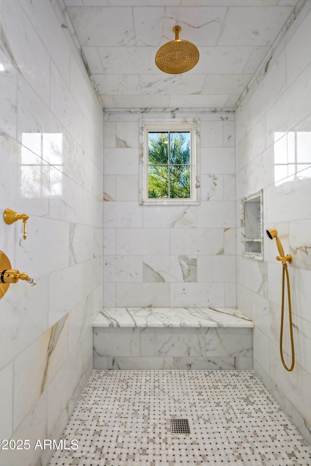 bathroom with tiled shower