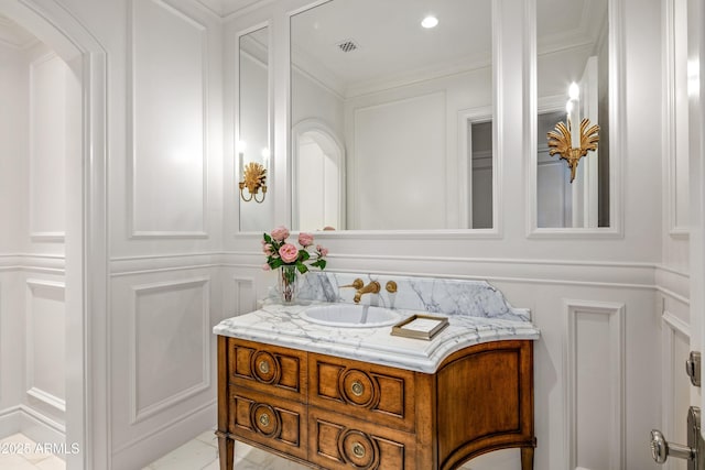 bathroom with crown molding and vanity