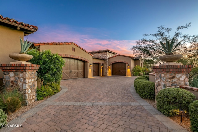 mediterranean / spanish home with a garage