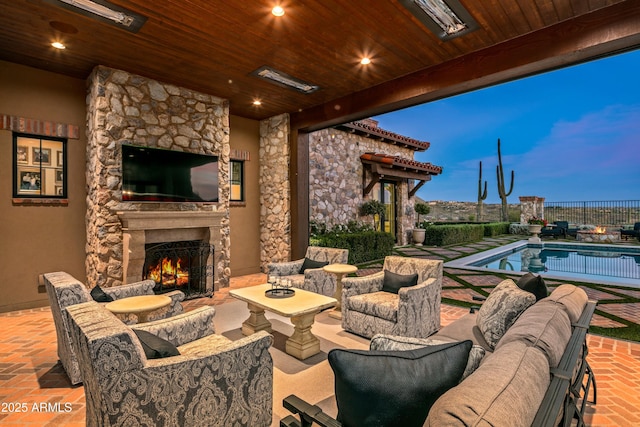 view of patio featuring an outdoor living space with a fireplace and a fenced in pool