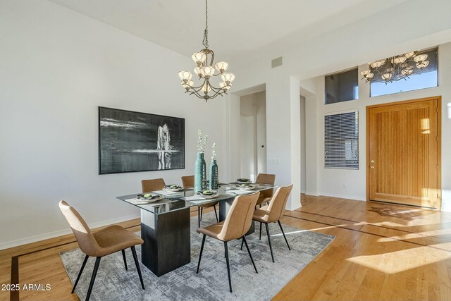 foyer with hardwood / wood-style flooring and a chandelier