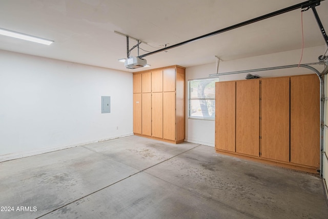 garage with electric panel and a garage door opener