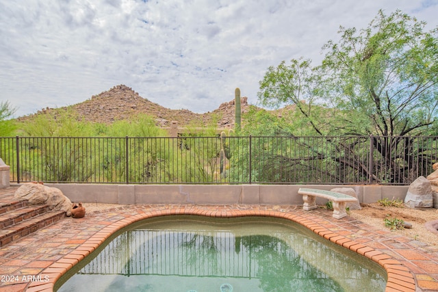 view of swimming pool with a mountain view