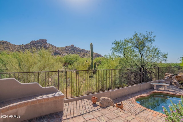 view of pool with a mountain view and a patio