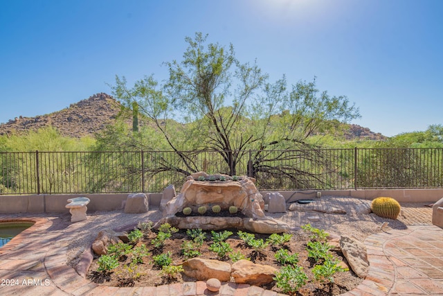 exterior space with a mountain view and fence