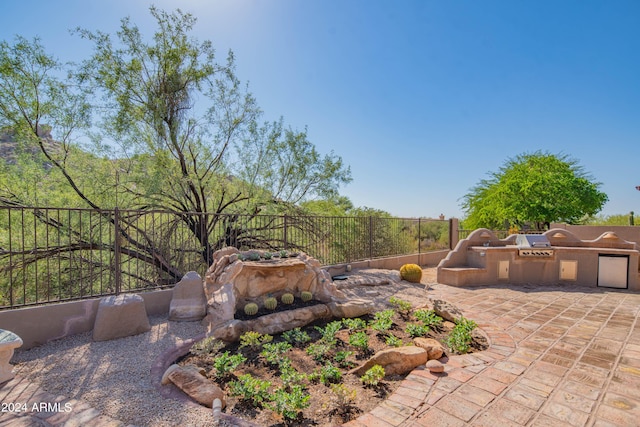 view of patio with a fenced backyard and an outdoor kitchen