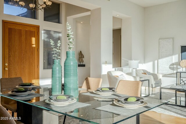 kitchen with hardwood / wood-style floors, white cabinetry, stainless steel appliances, hanging light fixtures, and kitchen peninsula