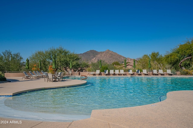 view of swimming pool with a mountain view and a patio area