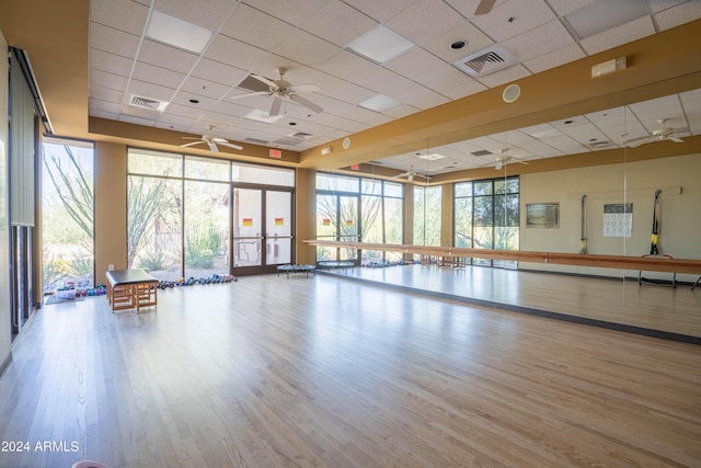 exercise area with light wood-style floors, visible vents, and floor to ceiling windows