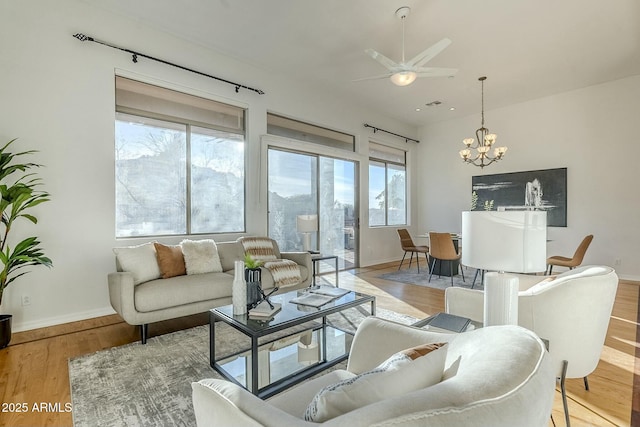 living area with light wood finished floors, plenty of natural light, and baseboards