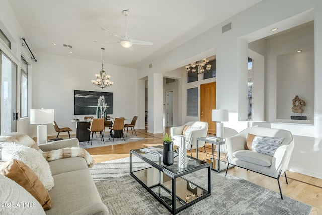 living room featuring recessed lighting, visible vents, light wood finished floors, and an inviting chandelier