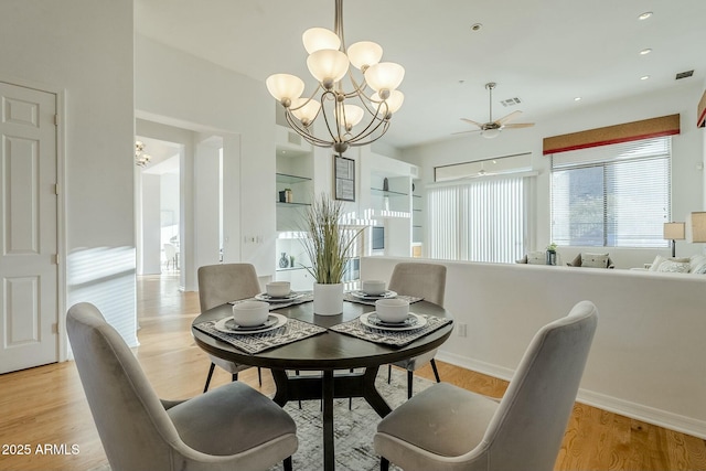 dining room with recessed lighting, visible vents, baseboards, light wood-style flooring, and ceiling fan with notable chandelier