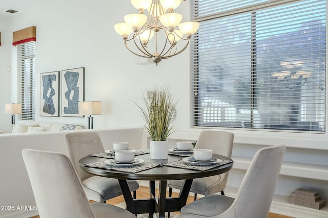 dining space with an inviting chandelier