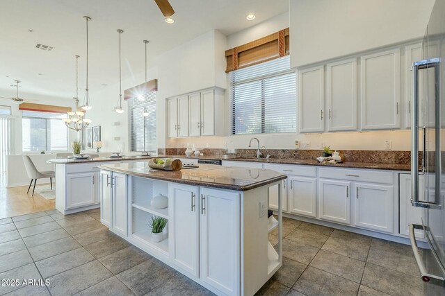 unfurnished room featuring a healthy amount of sunlight, light hardwood / wood-style flooring, and ceiling fan