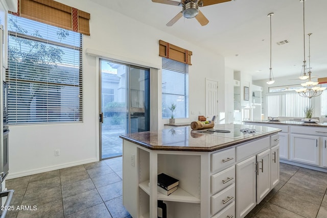 kitchen with a center island, white cabinetry, hanging light fixtures, white electric cooktop, and open shelves