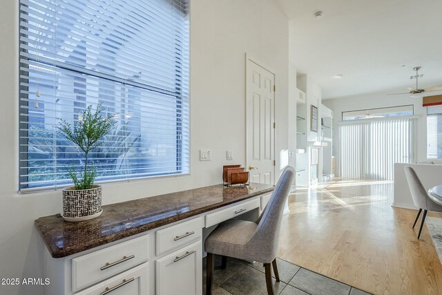 bathroom with vanity, ceiling fan, a relaxing tiled tub, and tile patterned flooring