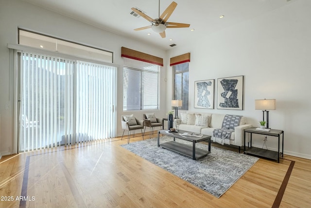 living room with visible vents, wood finished floors, a ceiling fan, and recessed lighting