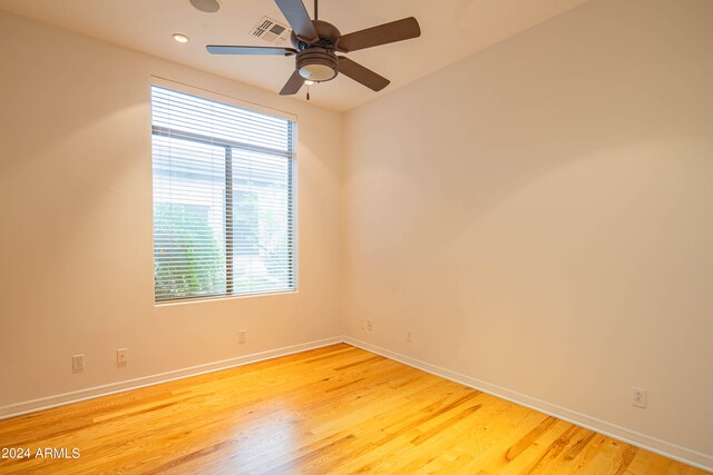 unfurnished room with ceiling fan and hardwood / wood-style floors