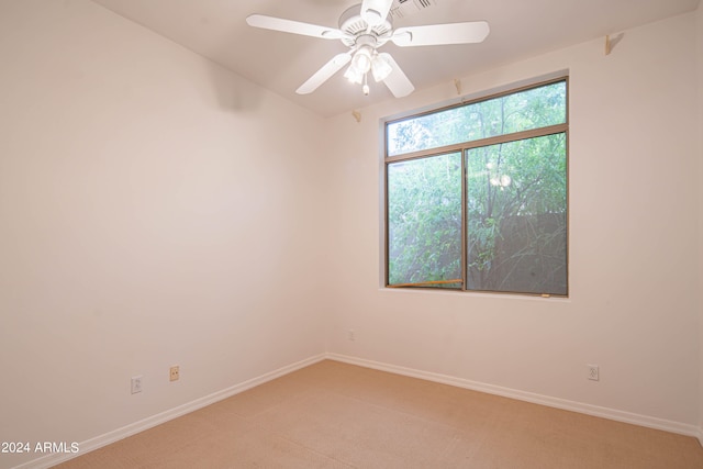 carpeted empty room featuring ceiling fan