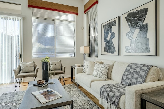 living area with light wood finished floors and baseboards