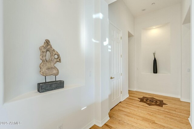 spare room featuring light hardwood / wood-style floors and ceiling fan with notable chandelier