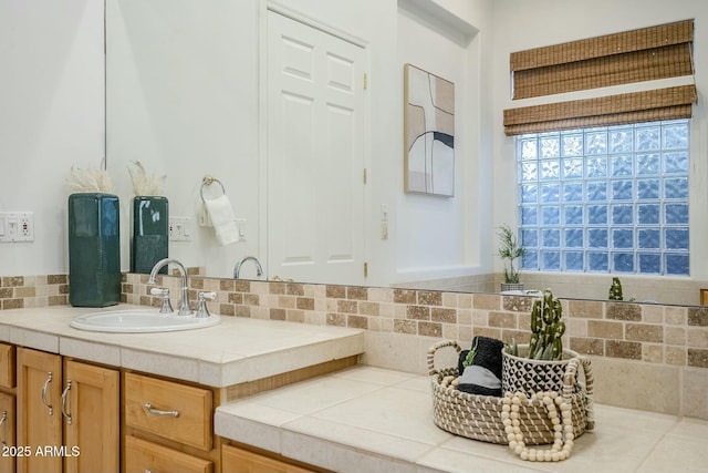 bathroom with vanity and decorative backsplash