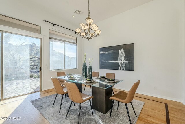 spare room featuring plenty of natural light, ceiling fan, and light hardwood / wood-style floors