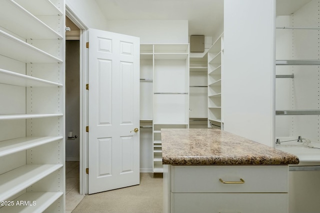 walk in closet with light tile patterned flooring