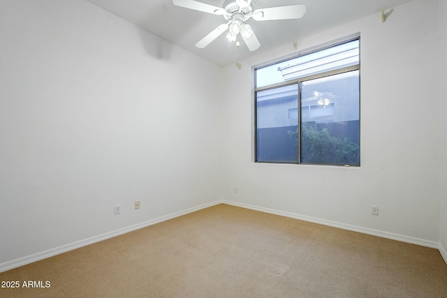 unfurnished room with light colored carpet, ceiling fan, and baseboards