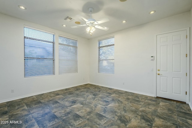 empty room with baseboards, visible vents, ceiling fan, stone finish flooring, and recessed lighting