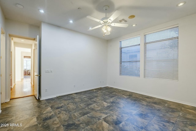 unfurnished room featuring recessed lighting, visible vents, stone finish floor, ceiling fan, and baseboards