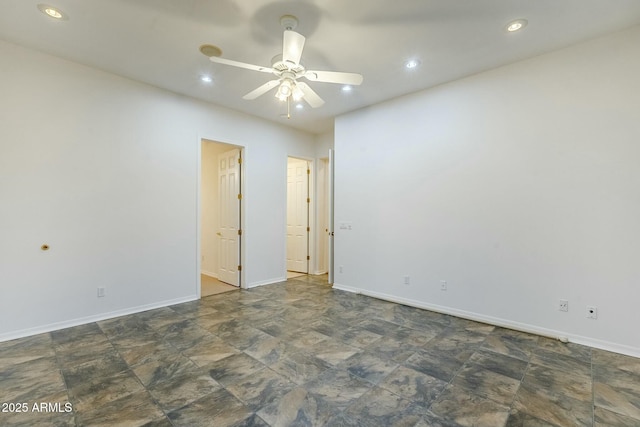 spare room with stone finish floor, ceiling fan, baseboards, and recessed lighting