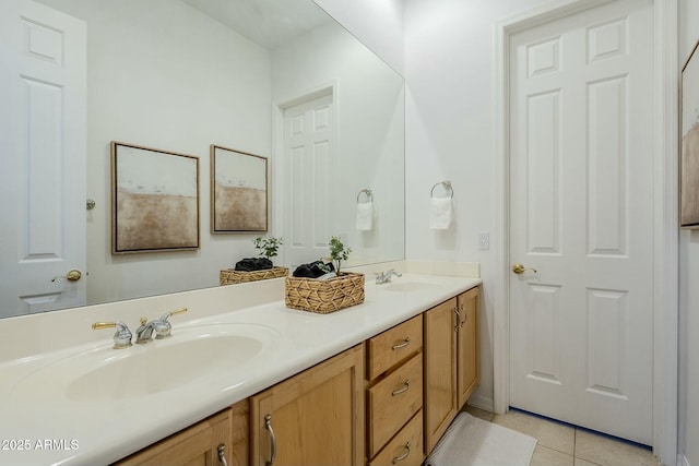 bathroom with double vanity, a sink, and tile patterned floors