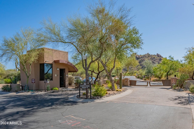 exterior space featuring a gate, fence, and stucco siding