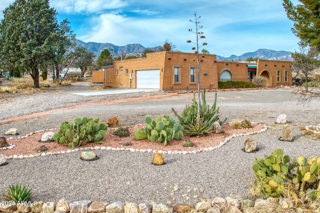 view of front of property featuring a garage and a mountain view