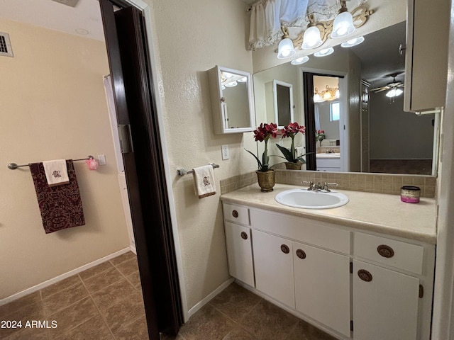 bathroom featuring visible vents, baseboards, ceiling fan, vanity, and tile patterned floors