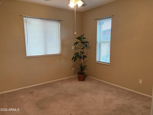 unfurnished room with baseboards, a ceiling fan, and carpet flooring