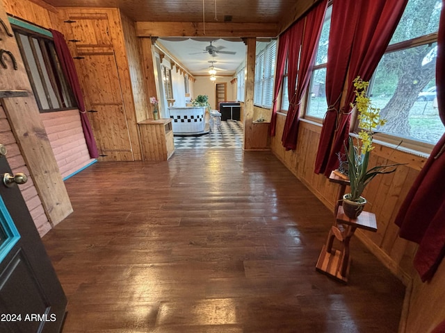 corridor with wood walls and wood finished floors